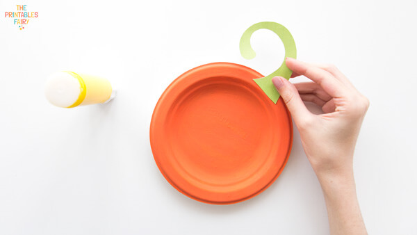 Gluing the green stem on the orange plate