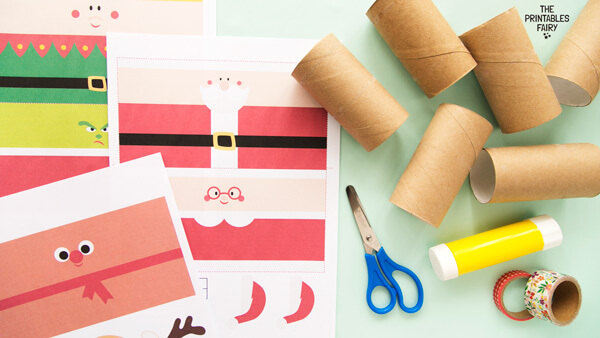 From left to right: Christmas Toilet Paper Roll Templates, 6 toilet paper rolls, scissors, glue stick, and washi tape.