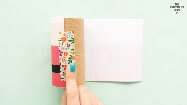 Taping one side of the Santa template onto the paper roll