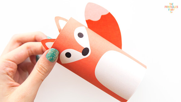 Gluing the ear to the fox toilet paper roll craft