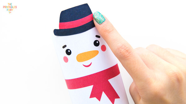 Gluing the hat to the snowman toilet paper roll craft
