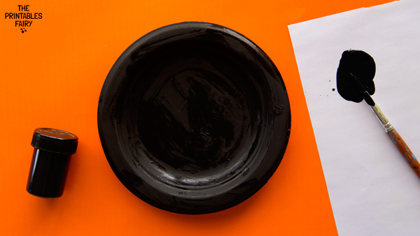 Painting the paper plate black
