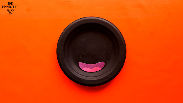 Gluing the mouth onto the paper plate